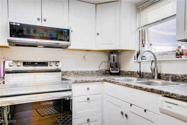 5706 W Lake Mead Blvd, Las Vegas, NV 89108 - kitchen with electric stove, white dishwasher, a sink, white cabinetry, and wood finished floors