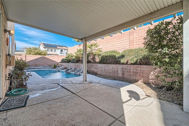 view of patio / terrace featuring a fenced backyard and a fenced in pool