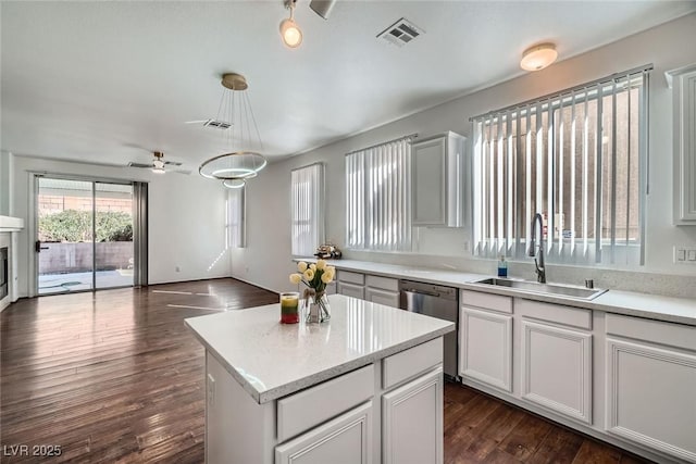 kitchen featuring visible vents, a sink, open floor plan, dishwasher, and dark wood-style flooring