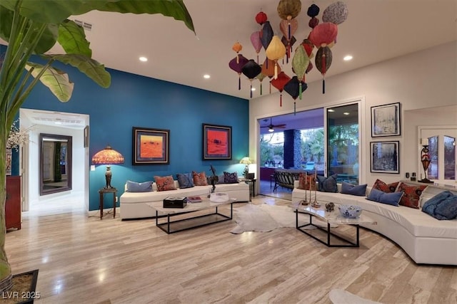 living room with visible vents, recessed lighting, and wood finished floors