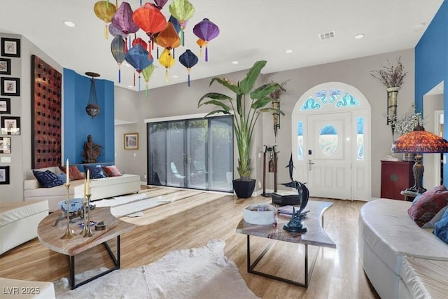 living area with visible vents, recessed lighting, and wood finished floors