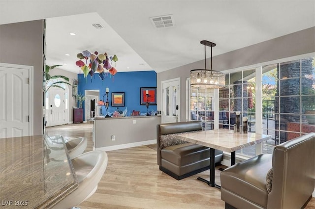 dining room with light wood finished floors, visible vents, recessed lighting, and baseboards