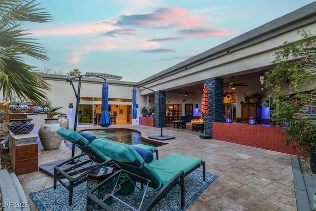 view of patio / terrace with an outdoor pool, outdoor lounge area, and ceiling fan