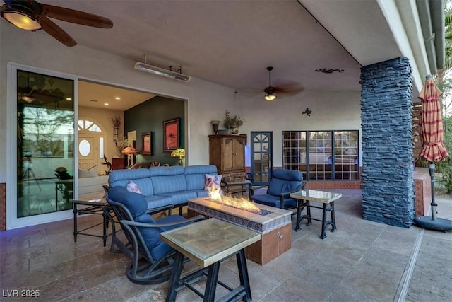 view of patio / terrace featuring an outdoor living space with a fire pit and ceiling fan