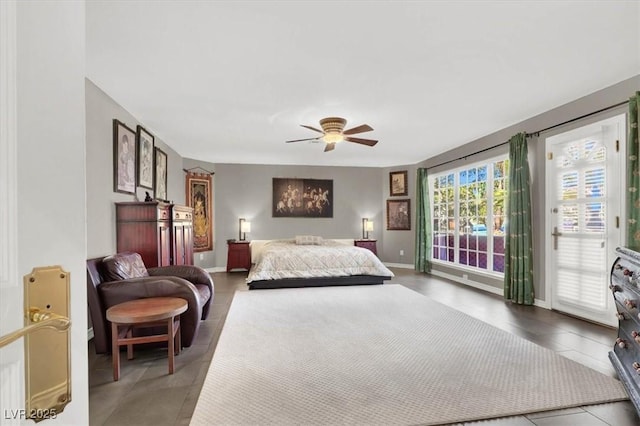 bedroom featuring access to outside, a ceiling fan, and baseboards