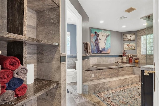 bathroom with visible vents, toilet, tile walls, and a bath