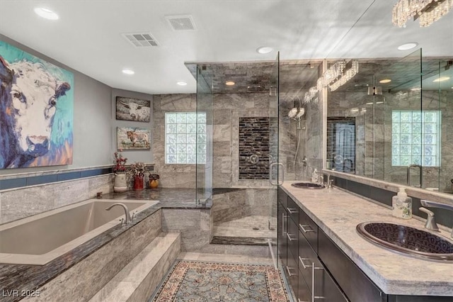 bathroom with a stall shower, visible vents, and a sink