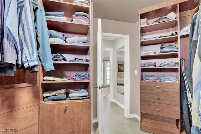 walk in closet featuring tile patterned flooring