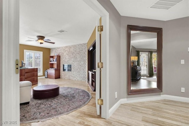 interior space featuring visible vents, baseboards, and wood finished floors