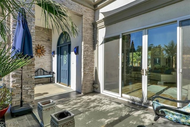 entrance to property with french doors and stone siding