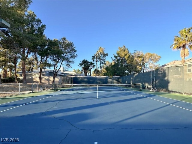 view of sport court featuring fence