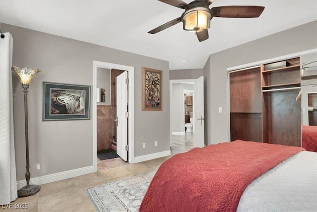 bedroom with a closet, connected bathroom, a ceiling fan, and baseboards