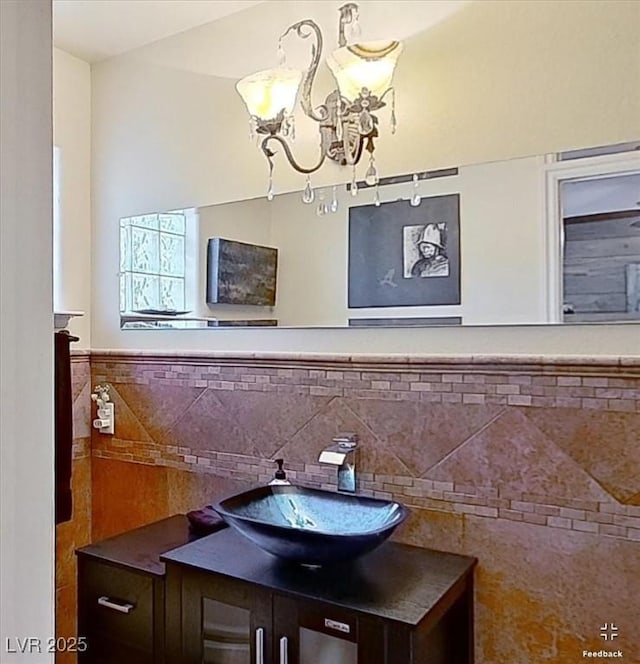 bathroom with vanity and a notable chandelier