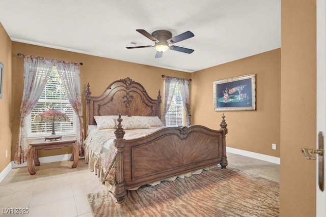 bedroom with multiple windows, baseboards, light tile patterned floors, and ceiling fan