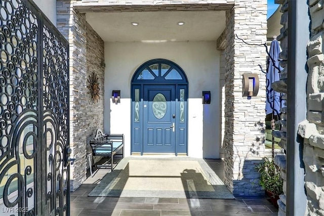 entrance to property with stucco siding