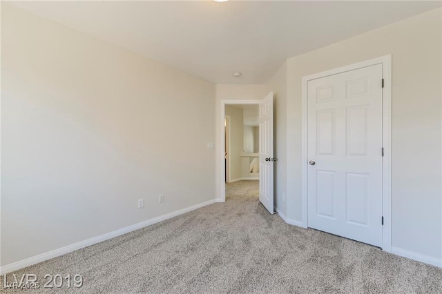 unfurnished bedroom featuring baseboards and carpet floors