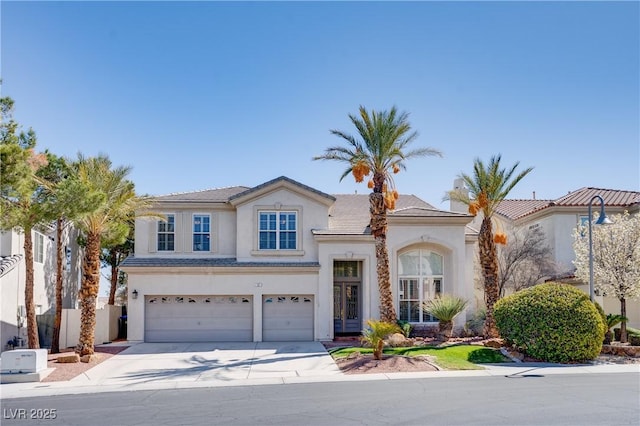 view of front of property featuring fence, driveway, stucco siding, a garage, and a tile roof