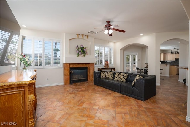 living area featuring recessed lighting, visible vents, a ceiling fan, and a tile fireplace