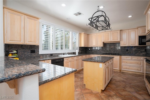 kitchen with visible vents, dishwasher, and light brown cabinetry