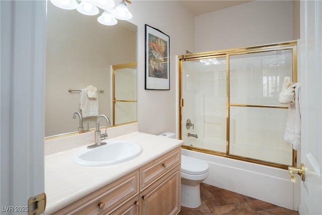 full bathroom with enclosed tub / shower combo, toilet, and vanity