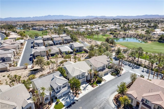 birds eye view of property with golf course view, a residential view, and a water and mountain view