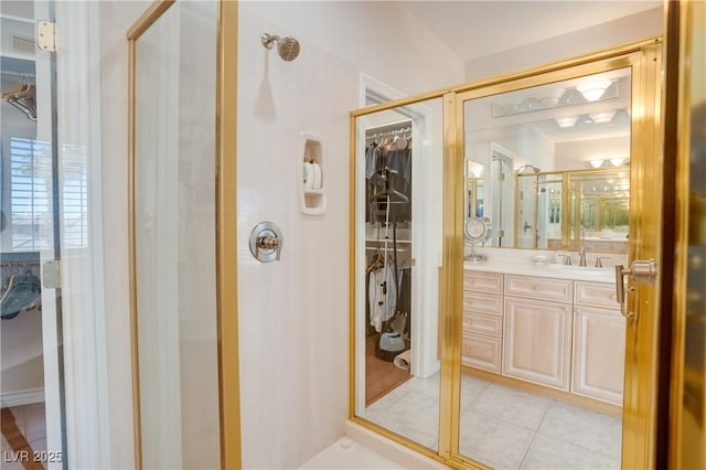 bathroom with vanity, visible vents, tile patterned flooring, a shower stall, and a spacious closet