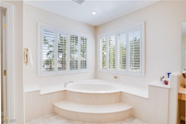 bathroom featuring tile patterned floors, a garden tub, and recessed lighting