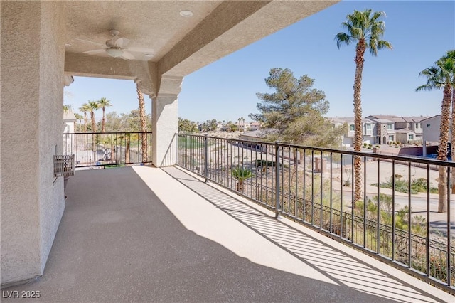 balcony featuring a residential view and a ceiling fan