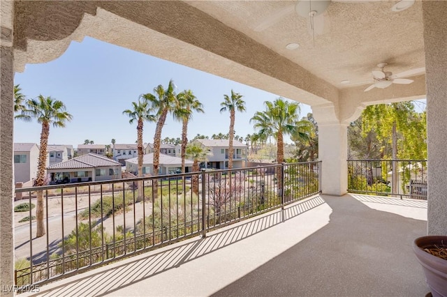 view of patio with a residential view, a balcony, and ceiling fan