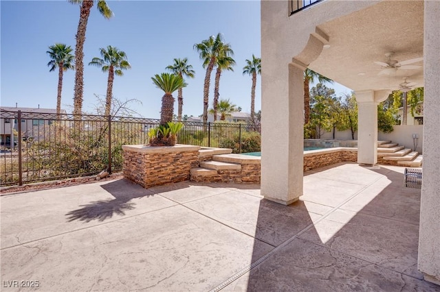 view of patio / terrace featuring a pool, a ceiling fan, and a fenced backyard