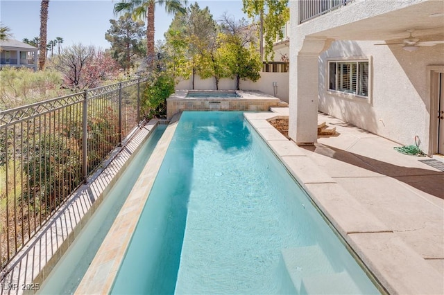 view of pool featuring a fenced in pool, a patio, a fenced backyard, an in ground hot tub, and a ceiling fan