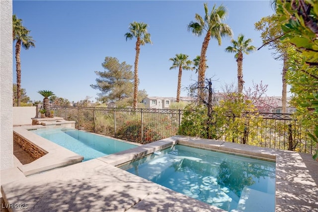 view of pool featuring a fenced in pool, an in ground hot tub, and a fenced backyard