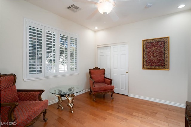 living area with a ceiling fan, visible vents, baseboards, recessed lighting, and light wood-style floors