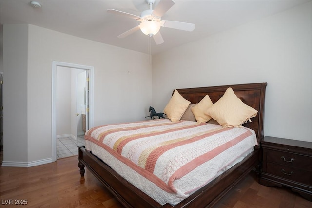 bedroom featuring a ceiling fan, wood finished floors, and baseboards