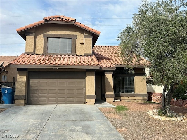 mediterranean / spanish-style house featuring stucco siding, driveway, and a tile roof