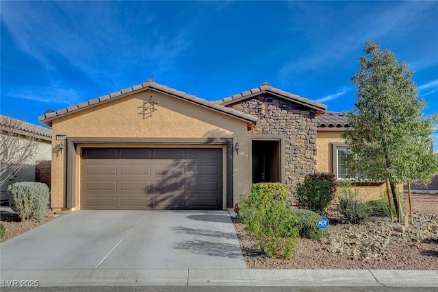 mediterranean / spanish-style house with stucco siding, a tile roof, stone siding, concrete driveway, and an attached garage