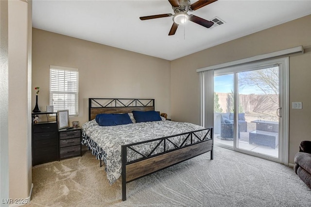 bedroom with access to exterior, multiple windows, visible vents, and light carpet