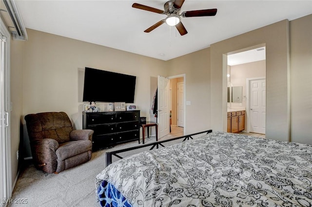 carpeted bedroom with connected bathroom and a ceiling fan