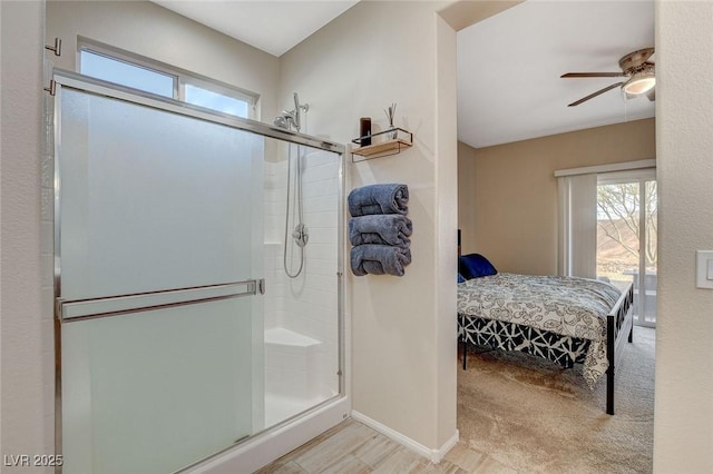 bathroom featuring ceiling fan, a stall shower, ensuite bath, and baseboards