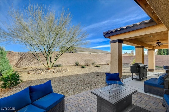 view of patio / terrace with ceiling fan, a grill, a fenced backyard, and an outdoor fire pit