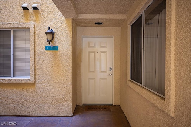 property entrance featuring stucco siding