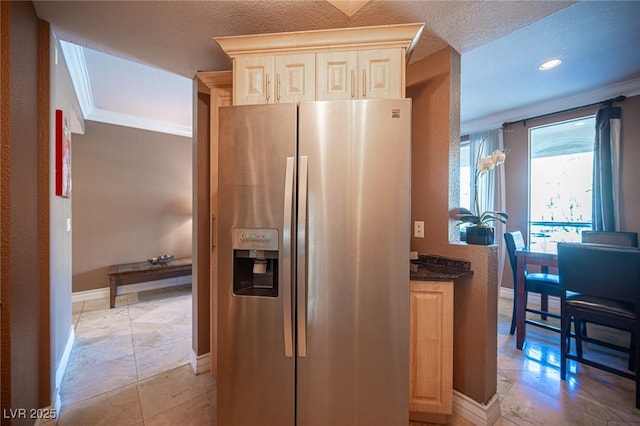 kitchen with crown molding, light brown cabinets, stainless steel refrigerator with ice dispenser, and baseboards