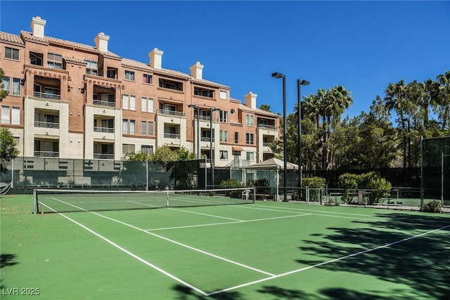 view of sport court featuring fence