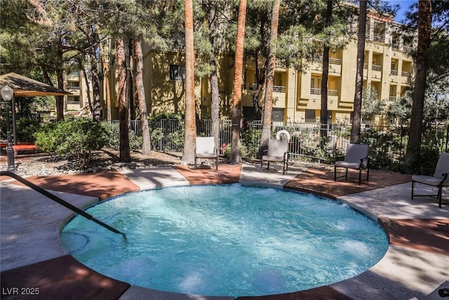 view of pool with a patio, a pool, and fence