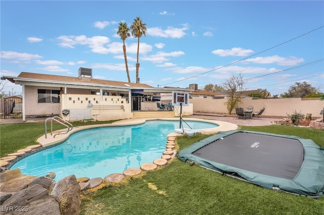 view of swimming pool featuring a patio area, a fenced in pool, a yard, and a fenced backyard