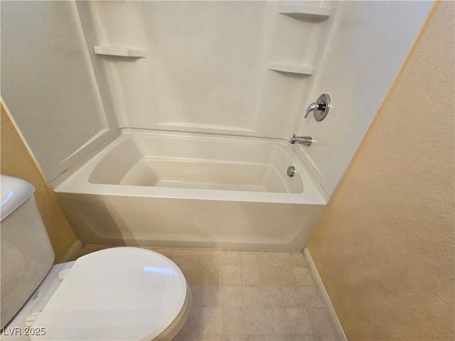 bathroom with baseboards, toilet, and  shower combination