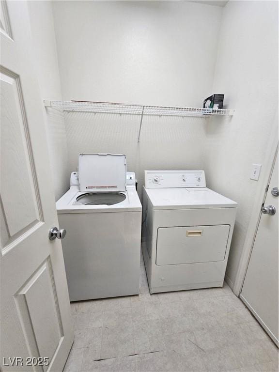 washroom featuring laundry area and washing machine and dryer