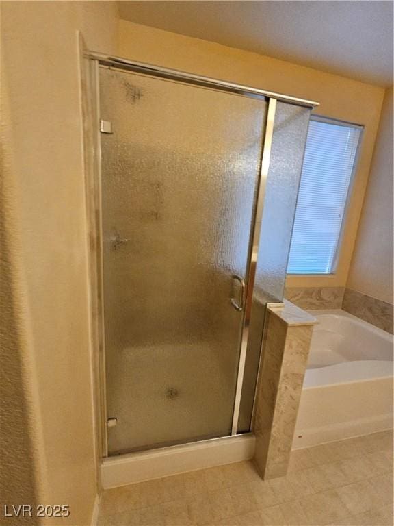 full bathroom with a bath and a stall shower