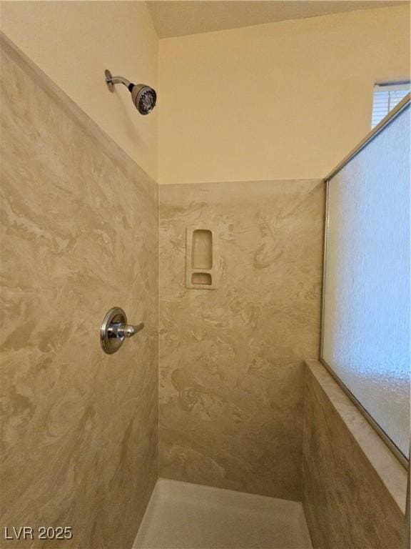 full bath featuring a tile shower