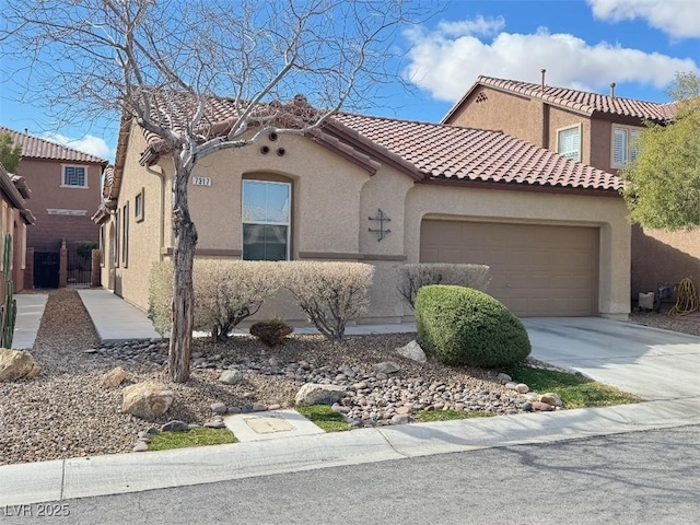 mediterranean / spanish-style home featuring stucco siding, driveway, a tile roof, and a garage